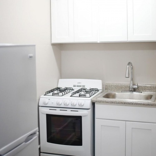 a kitchen with white cabinets