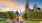 a park with a fountain and tall buildings in the background