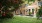 a brick building with a green lawn